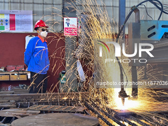 A worker works in a mechanical manufacturing enterprise in Qingzhou, China, on October 18, 2024. On the same day, the National Bureau of Sta...