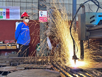 A worker works in a mechanical manufacturing enterprise in Qingzhou, China, on October 18, 2024. On the same day, the National Bureau of Sta...