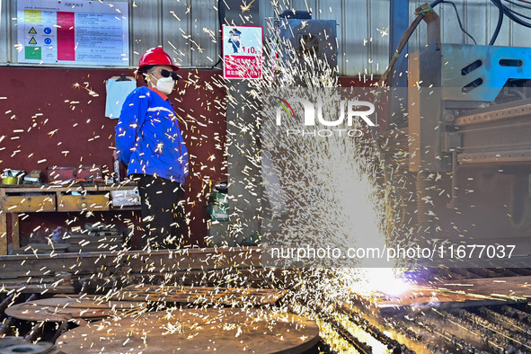 A worker works in a mechanical manufacturing enterprise in Qingzhou, China, on October 18, 2024. On the same day, the National Bureau of Sta...