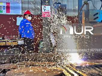 A worker works in a mechanical manufacturing enterprise in Qingzhou, China, on October 18, 2024. On the same day, the National Bureau of Sta...