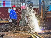 A worker works in a mechanical manufacturing enterprise in Qingzhou, China, on October 18, 2024. On the same day, the National Bureau of Sta...