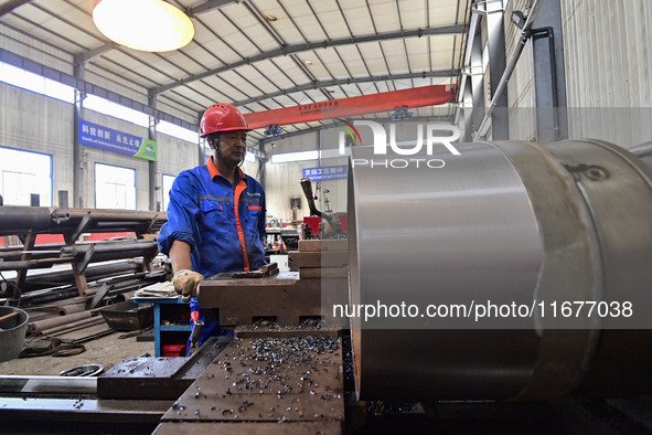 A worker works in a mechanical manufacturing enterprise in Qingzhou, China, on October 18, 2024. On the same day, the National Bureau of Sta...