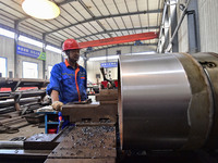 A worker works in a mechanical manufacturing enterprise in Qingzhou, China, on October 18, 2024. On the same day, the National Bureau of Sta...