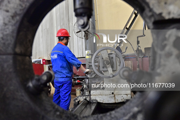 A worker works in a mechanical manufacturing enterprise in Qingzhou, China, on October 18, 2024. On the same day, the National Bureau of Sta...