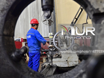 A worker works in a mechanical manufacturing enterprise in Qingzhou, China, on October 18, 2024. On the same day, the National Bureau of Sta...