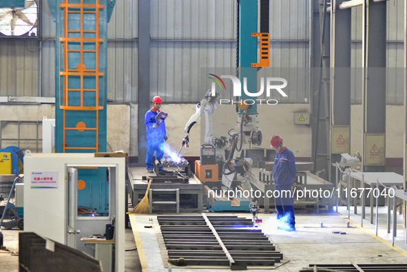 A worker works in a mechanical manufacturing enterprise in Qingzhou, China, on October 18, 2024. On the same day, the National Bureau of Sta...