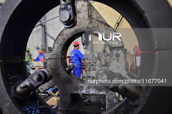 A worker works in a mechanical manufacturing enterprise in Qingzhou, China, on October 18, 2024. On the same day, the National Bureau of Sta...