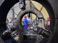 A worker works in a mechanical manufacturing enterprise in Qingzhou, China, on October 18, 2024. On the same day, the National Bureau of Sta...