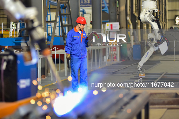 A worker works in a mechanical manufacturing enterprise in Qingzhou, China, on October 18, 2024. On the same day, the National Bureau of Sta...