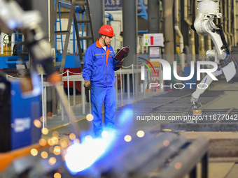 A worker works in a mechanical manufacturing enterprise in Qingzhou, China, on October 18, 2024. On the same day, the National Bureau of Sta...