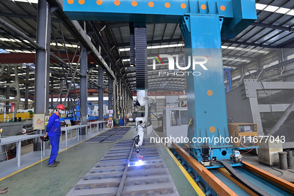 A worker works in a mechanical manufacturing enterprise in Qingzhou, China, on October 18, 2024. On the same day, the National Bureau of Sta...