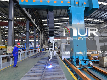 A worker works in a mechanical manufacturing enterprise in Qingzhou, China, on October 18, 2024. On the same day, the National Bureau of Sta...