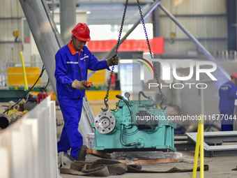 A worker works in a mechanical manufacturing enterprise in Qingzhou, China, on October 18, 2024. On the same day, the National Bureau of Sta...