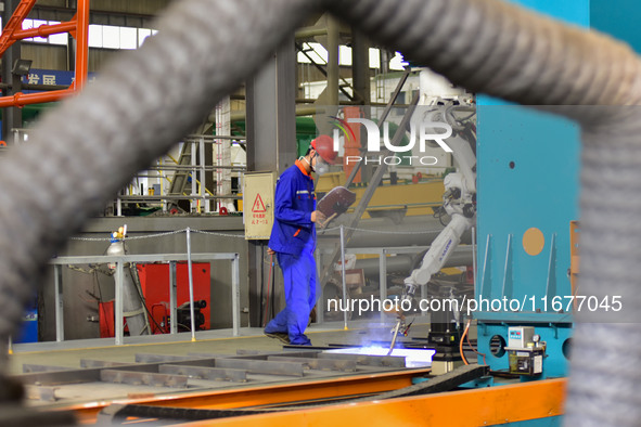 A worker works in a mechanical manufacturing enterprise in Qingzhou, China, on October 18, 2024. On the same day, the National Bureau of Sta...