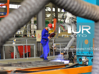 A worker works in a mechanical manufacturing enterprise in Qingzhou, China, on October 18, 2024. On the same day, the National Bureau of Sta...