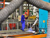 A worker works in a mechanical manufacturing enterprise in Qingzhou, China, on October 18, 2024. On the same day, the National Bureau of Sta...