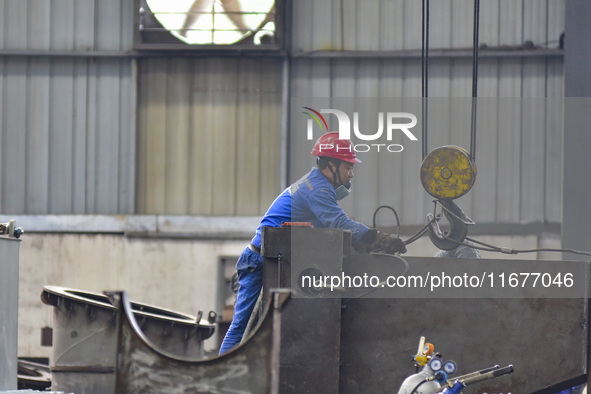 A worker works in a mechanical manufacturing enterprise in Qingzhou, China, on October 18, 2024. On the same day, the National Bureau of Sta...