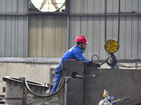 A worker works in a mechanical manufacturing enterprise in Qingzhou, China, on October 18, 2024. On the same day, the National Bureau of Sta...