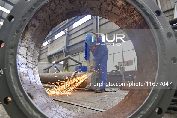 A worker works in a mechanical manufacturing enterprise in Qingzhou, China, on October 18, 2024. On the same day, the National Bureau of Sta...