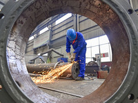 A worker works in a mechanical manufacturing enterprise in Qingzhou, China, on October 18, 2024. On the same day, the National Bureau of Sta...