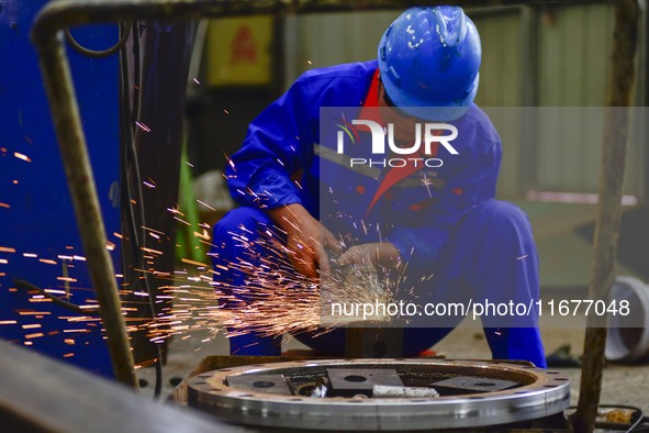 A worker works in a mechanical manufacturing enterprise in Qingzhou, China, on October 18, 2024. On the same day, the National Bureau of Sta...