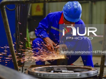 A worker works in a mechanical manufacturing enterprise in Qingzhou, China, on October 18, 2024. On the same day, the National Bureau of Sta...