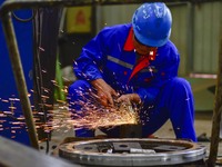 A worker works in a mechanical manufacturing enterprise in Qingzhou, China, on October 18, 2024. On the same day, the National Bureau of Sta...