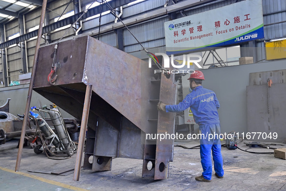 A worker works in a mechanical manufacturing enterprise in Qingzhou, China, on October 18, 2024. On the same day, the National Bureau of Sta...