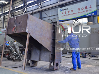 A worker works in a mechanical manufacturing enterprise in Qingzhou, China, on October 18, 2024. On the same day, the National Bureau of Sta...