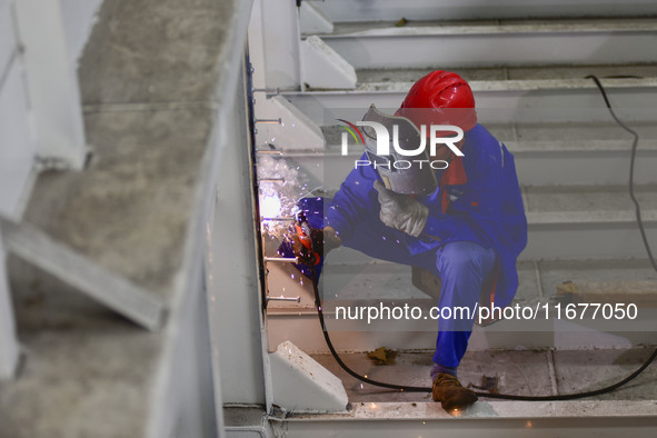 A worker works in a mechanical manufacturing enterprise in Qingzhou, China, on October 18, 2024. On the same day, the National Bureau of Sta...