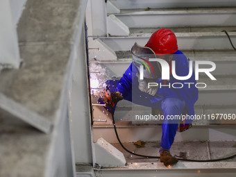 A worker works in a mechanical manufacturing enterprise in Qingzhou, China, on October 18, 2024. On the same day, the National Bureau of Sta...