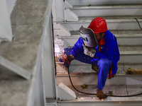 A worker works in a mechanical manufacturing enterprise in Qingzhou, China, on October 18, 2024. On the same day, the National Bureau of Sta...