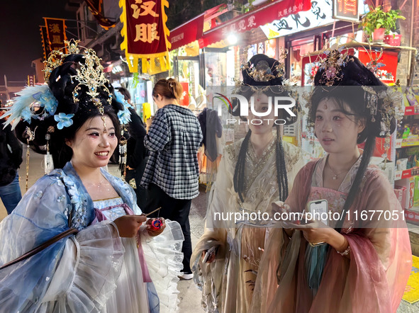 Tourists dressed in Hanfu visit the ancient city of Luoyi in Luoyang, Henan province, China, on October 16, 2024. 