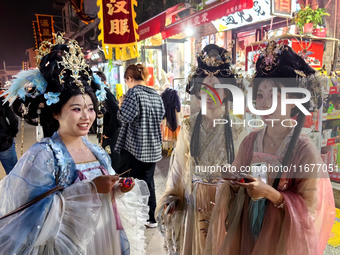 Tourists dressed in Hanfu visit the ancient city of Luoyi in Luoyang, Henan province, China, on October 16, 2024. (