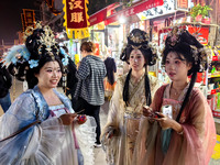 Tourists dressed in Hanfu visit the ancient city of Luoyi in Luoyang, Henan province, China, on October 16, 2024. (