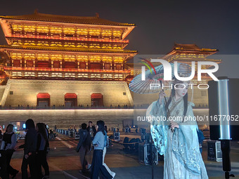 Tourists dressed in Hanfu visit the ancient city of Luoyi in Luoyang, Henan province, China, on October 16, 2024. (