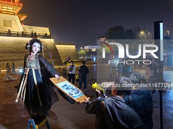 Tourists dressed in Hanfu visit the ancient city of Luoyi in Luoyang, Henan province, China, on October 16, 2024. (