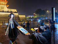 Tourists dressed in Hanfu visit the ancient city of Luoyi in Luoyang, Henan province, China, on October 16, 2024. (