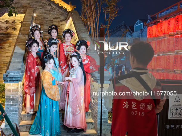 Tourists dressed in Hanfu visit the ancient city of Luoyi in Luoyang, Henan province, China, on October 16, 2024. 