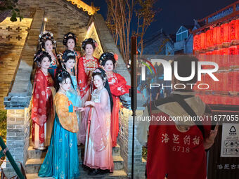 Tourists dressed in Hanfu visit the ancient city of Luoyi in Luoyang, Henan province, China, on October 16, 2024. (