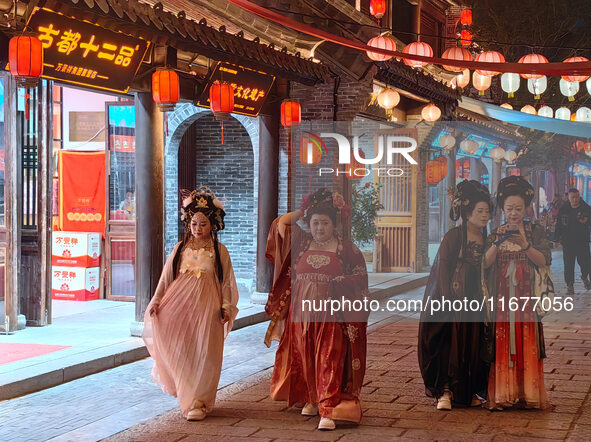 Tourists dressed in Hanfu visit the ancient city of Luoyi in Luoyang, Henan province, China, on October 16, 2024. 