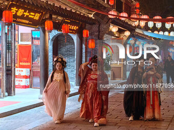 Tourists dressed in Hanfu visit the ancient city of Luoyi in Luoyang, Henan province, China, on October 16, 2024. (