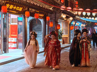 Tourists dressed in Hanfu visit the ancient city of Luoyi in Luoyang, Henan province, China, on October 16, 2024. (