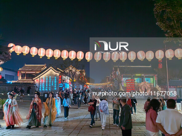 Tourists dressed in Hanfu visit the ancient city of Luoyi in Luoyang, Henan province, China, on October 16, 2024. 