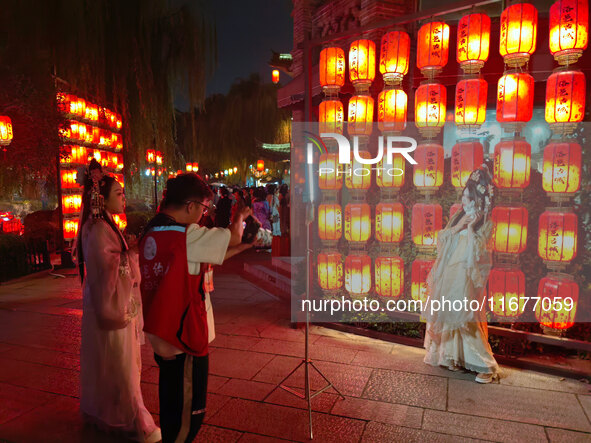 Tourists dressed in Hanfu visit the ancient city of Luoyi in Luoyang, Henan province, China, on October 16, 2024. 