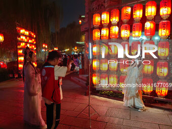 Tourists dressed in Hanfu visit the ancient city of Luoyi in Luoyang, Henan province, China, on October 16, 2024. (