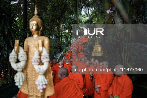 Thai Buddhist monks prepare for a morning alms ritual to mark the end of the Buddhist Lent, known as 'Awk Phansa day', at Golden Mount templ...