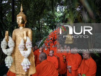 Thai Buddhist monks prepare for a morning alms ritual to mark the end of the Buddhist Lent, known as 'Awk Phansa day', at Golden Mount templ...