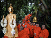 Thai Buddhist monks prepare for a morning alms ritual to mark the end of the Buddhist Lent, known as 'Awk Phansa day', at Golden Mount templ...