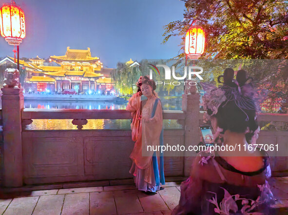 Tourists dressed in Hanfu visit the ancient city of Luoyi in Luoyang, Henan province, China, on October 16, 2024. 